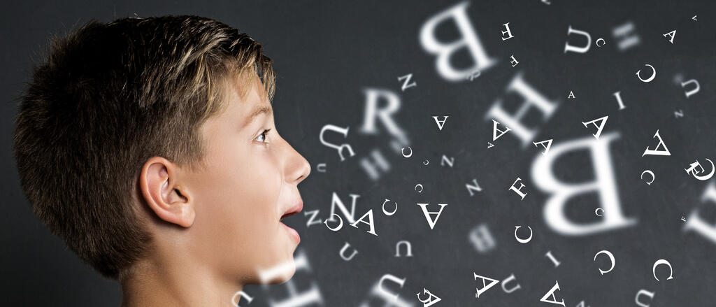 Symboldbild: Aus dem Mund eines Jungen gehen Buchstaben hervor